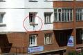 Woman hanging out of the window - Sakshi Post
