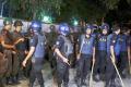 Members of Rapid Action Battalion stand guard outside Holey Artisan Bakery - Sakshi Post