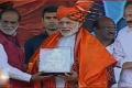 Telangana BJP president Dr. K. Lakshman felicitates Narendra Modi at a party meeting in Hyderabad on Sunday. - Sakshi Post