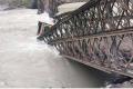 According to government officials, 76 meters of the bridge on 10 pillars were washed away by flood waters. - Sakshi Post