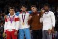 Besik Kudukhov (extreme left) with Yogeshwar Dutt (extreme right) and other medal winners at the 2012 London Olympics. - Sakshi Post