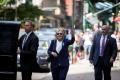 A video posted on Twitter shows the 68-year-old Clinton stumbled and she was being helped by her staff into a waiting van and left the memorial service early A video posted on Twitter shows the 68-year-old Clinton stumbled and she was being helped by her staff into a waiting van and left the memorial service early - Sakshi Post