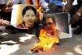 Protesters burn posters of Tamil Nadu CM J. Jayalalithaa and Karnataka CM Siddaramaiah. - Sakshi Post