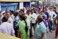 SBI customers were standing in serpentine queues at the bank to withdraw money - Sakshi Post