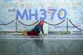A wall with signatures and messages in support of the families of MH370 victims. - Sakshi Post