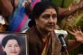 At the Jayalalithaa memorial on the Marina Beach, Sasikala paid floral tributes and was seen muttering something which was not audible - Sakshi Post