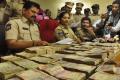 Police displays the seized currency notes - Sakshi Post