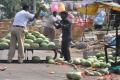 A police official throws water melon to the ground - Sakshi Post