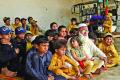 Pakistani father Gulzar Khan, who has 36 children from his three wives, sits with his children - Sakshi Post