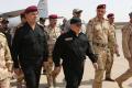 Iraqi Prime Minister Haider al-Abadi (black military uniform and black cap) arrives in  Mosul to announce the recapture of the city. - Sakshi Post