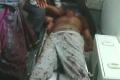 The blood-soaked body of corporator Anisetty Murali - Sakshi Post