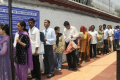 People wait outside the U.S. Consulate in Chennai for visa interviews in this file photo People wait outside the U.S. Consulate in Chennai for visa interviews in this file photo - Sakshi Post