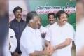 A smiling K Palaniswami and O Panneerselvam shook hands signifying the formal merger of both the factions at the party headquarters, on Monday. - Sakshi Post