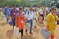 Polling officials carry voting machines to their designated polling booths prior to the bypolls in Goa. - Sakshi Post