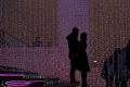 In this 2014 archive photo, a couple hug each other in front of a light installation for Christmas celebrations in Beijing, China. - Sakshi Post