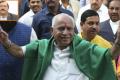 Bharatiya Janata Party (BJP) leader B. S. Yeddyurappa flashes victory sign as he arrives at governors house to take oath as Chief Minister of Karnataka state in Bangalore. - Sakshi Post