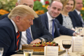U.S. President Donald Trump blows out a candle on a cake celebrating an early birthday during lunch with Singapores Prime Minister Lee Hsien Loong - Sakshi Post
