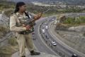 A paramilitary soldier stands guard as the first batch of pilgrims leaves for Amarnath Yatra &amp;amp;nbsp; - Sakshi Post