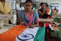 Women stitch the national flag at the Indian National Flag Production Centre in Bengeri - Sakshi Post
