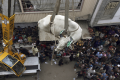 A bull being lowered from top of a building in Karachi, Pakistan - Sakshi Post