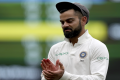 Indias captain Virat Kohli walks from the field at the close of play on day o the first cricket test between Australia and India in Adelaide - Sakshi Post