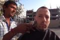 Harald Baldr getting his hair cut on the streets of Ahmedabad - Sakshi Post