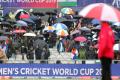 Spectators take shelter under their umbrellas after rain stopped play during the Cricket World Cup match between India and Pakistan at Old Trafford in Manchester &amp;amp;nbsp; - Sakshi Post