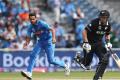 Indias Bhuvneshwar Kumar, left, runs to field the ball after a shot played by New Zealands Tom Latham &amp;amp;nbsp; - Sakshi Post