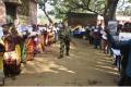 A security man guarding the polling booth while during election in Jharkhand - Sakshi Post