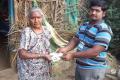 Village volunteer distributing monetary cash Village volunteer distributing monetary cash - Sakshi Post