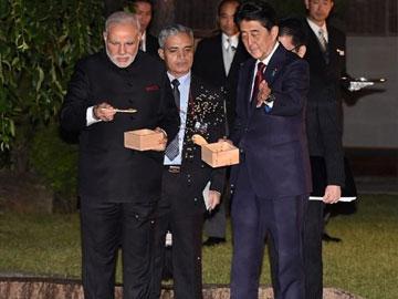 Modi's begins Japanese tour, feeds fish, gifts books - Sakshi Post