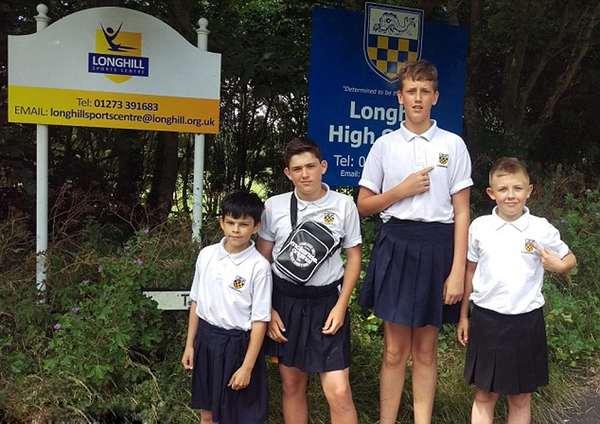 Four boys at the Longhill High School, in Brighton, East Sussex, wore skirts to school in protest after they were pulled up for wearing shorts - Sakshi Post