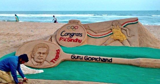Sand sculpture of PV Sindhu and her coach Gopichand by Sudarsan Pattnaik. - Sakshi Post
