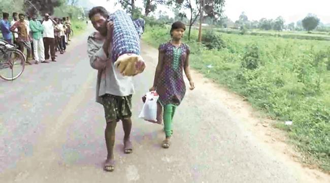 Dana Majhi walked 10 km distance carrying his wife’s body on his shoulder along with his 12-year old daughter. - Sakshi Post
