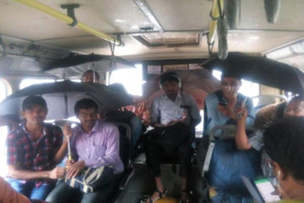 Passengers travelling in Limgampally-Dilsukhnagar  bus were seen using umbrellas inside the bus as the roof was leaking - Sakshi Post