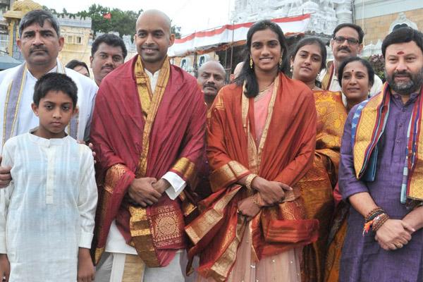 Coach Gopichand and PV Sindhu with her parents and temple officials in Tirumala, on Sunday. - Sakshi Post