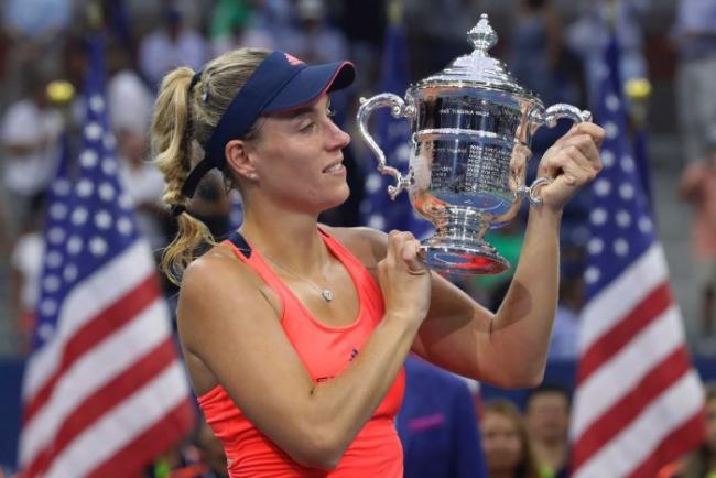 Germany’s Angelique Kerber holds the US Open trophy after beating Karolina Pliskova in the final. - Sakshi Post