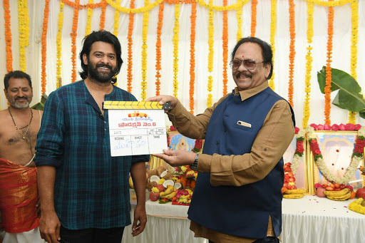 Senior actor, ex-Union Minister Krishnam Raju clapping the board on Prabhas for Muhurat shot in Hyderabad on Monday. - Sakshi Post