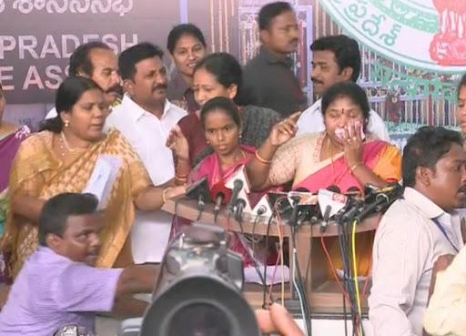 Minister P Sujatha and TDP male MLAs trying to prevent YSRCP woman MLAs from addressing media. - Sakshi Post