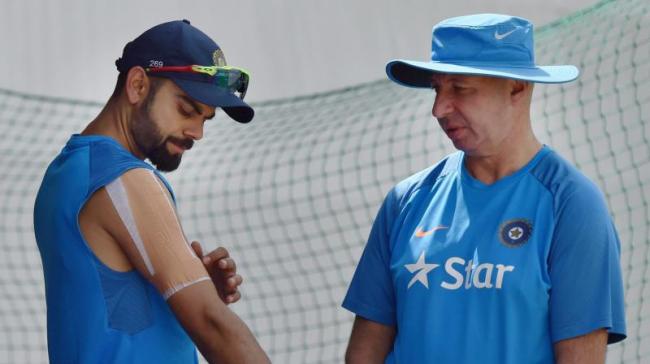 Virat Kohli is nursing an injury on his right shoulder sustained while trying to save a boundary in Australia’s first innings at Ranchi. - Sakshi Post