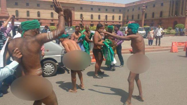 A group of Tamil Nadu farmers on Monday stripped near South Block here to press for their demands of loan waiver and drought-relief package. A group of Tamil Nadu farmers on Monday stripped near South Block here to press for their demands of loan waiver and drought-relief package. - Sakshi Post