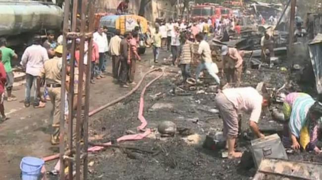 The huts were completely razed to ashes within minutes in a major fire accident at Nampally on Friday. - Sakshi Post