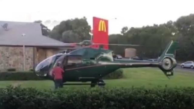 The green chopper set down on a grassy patch outside McDonald’s branch in Sydney with locals left stunned by the incident. - Sakshi Post