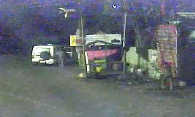 The screengrab of CCTV shows the police official destroying the BJP flagpost The screengrab of CCTV shows the police official destroying the BJP flagpost - Sakshi Post