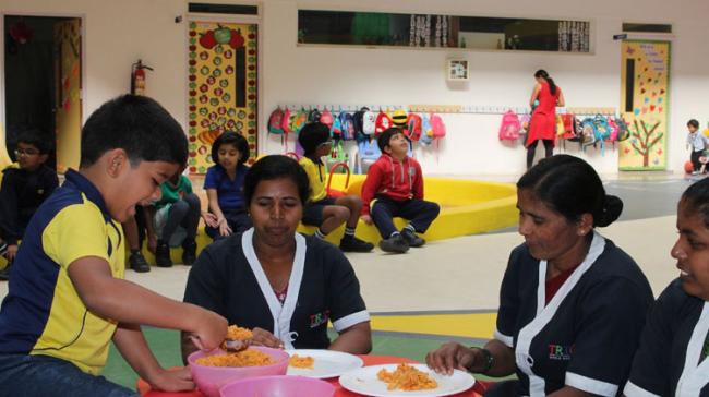 Kids serving breakfast to their nannies to mark Thanksgiving Day, on Thursday. - Sakshi Post