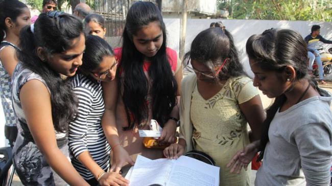 Students brush up their knowledge before entering the exam hall (representational image) - Sakshi Post