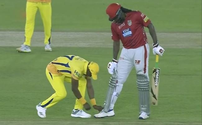 When Gayle was at the batting end, his shoe laces came off and he sought some help from KXIP player Dwayne Bravo. - Sakshi Post