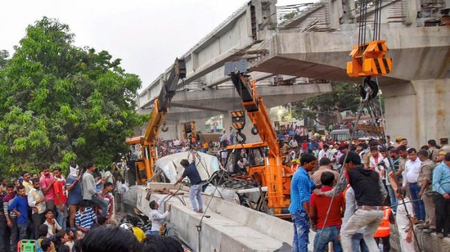Rescue teams gather near crushed vehicles after an under-construction flyover collapsed in Varanasi - Sakshi Post