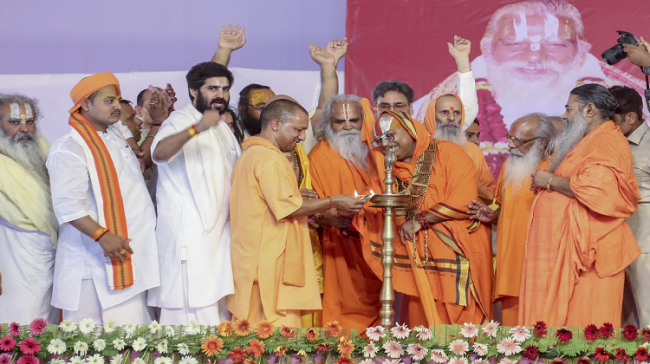 UP CM Yogi Adityanath lights the lamp during a function to celebrate the 80th birthday of Ram Janam Bhoomi Trust President Nritya Gopal Das, in Ayodhya - Sakshi Post