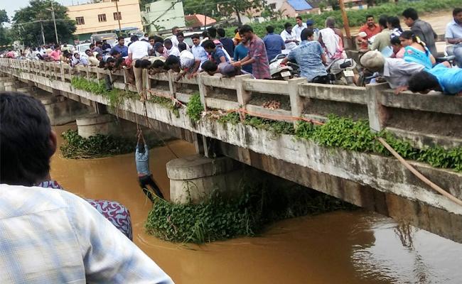 The man being rescued from the drain - Sakshi Post